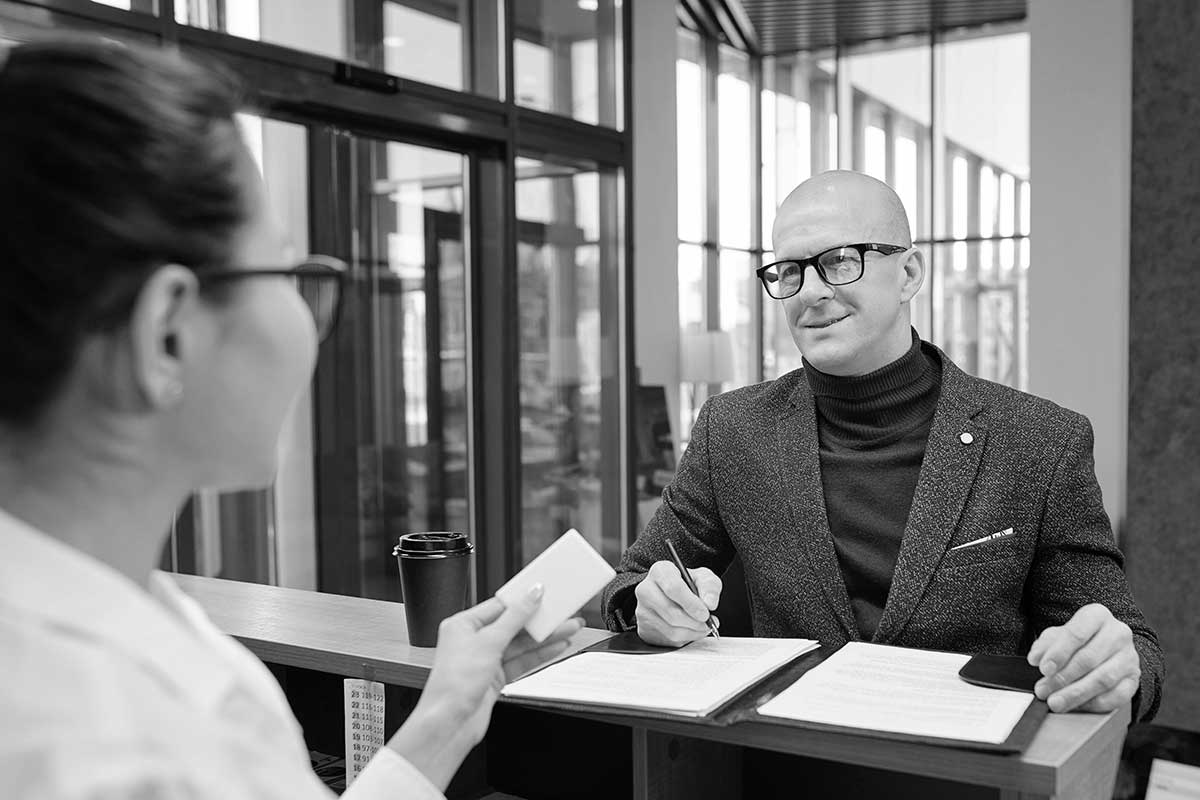 Mann og kvinne diskuterer dokumenter på kontor